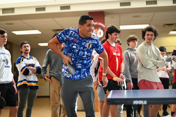 Former College Table Tennis National Champion David Cabrera challenging a student in a match.  