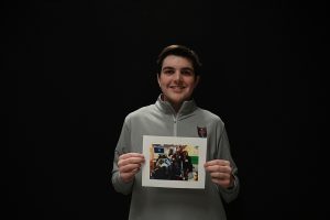 John Delaney '26 holds a photo of him in the hospital with his parents. Delaney battles with a rare condition of scoliosis, in which he was diagnosed at a very young age. 