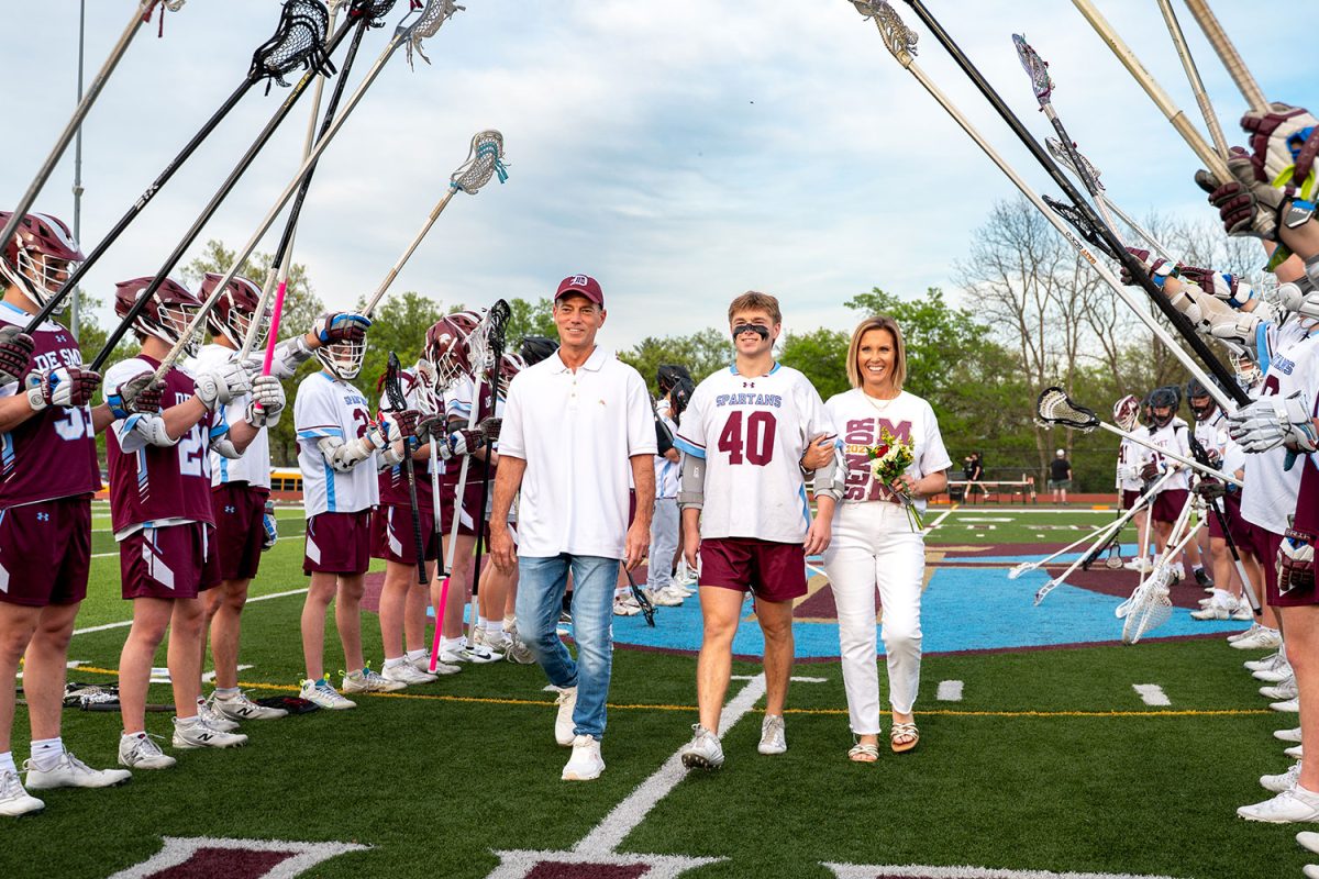 Jack McManus '25 walks with parents for senior celebration on April 23rd, 2025.