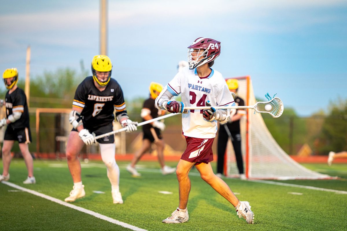 Bryson Delisi '26 passes ball upfield on April 23rd, 2025.