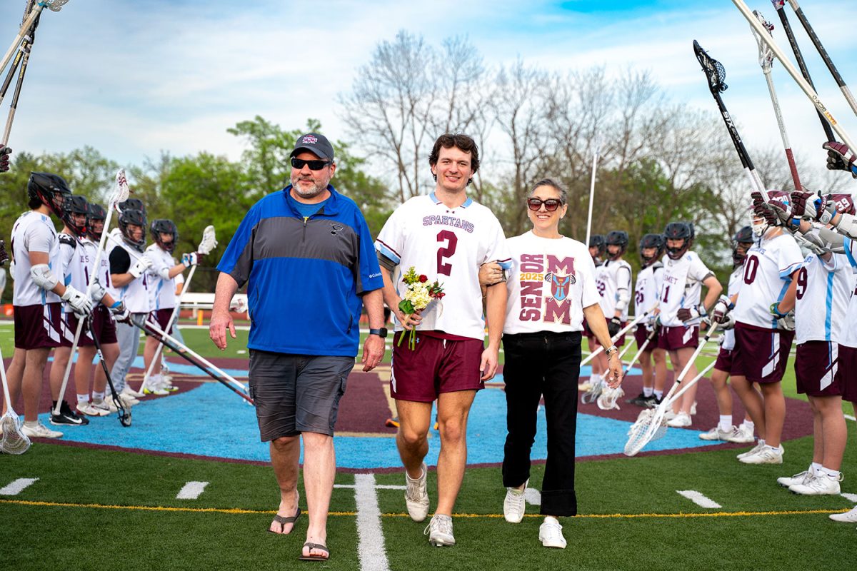 William Harbaugh '25 walks with parents for senior celebration on April 23rd, 2025.