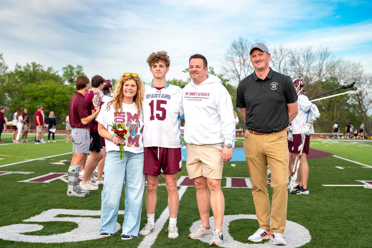 Colin Kemp '25 stands with parents and coach for senior celebration on April 23rd, 2025.