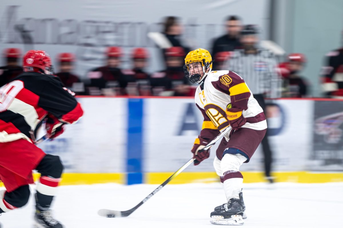 Joey Buzzeta '26 handles the puck in the state championship game against Chaminade.