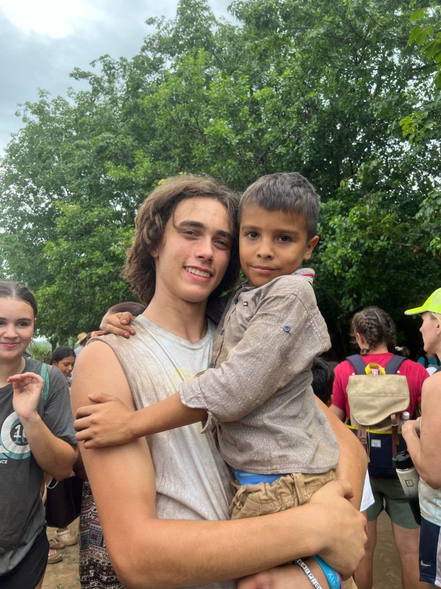 Jack Reineke holds Anderson, who is a resident of the San Benito community. Jack’s youth group from Incarnate Word was digging ditches and moving rocks to lay water pipes from the well to the community.