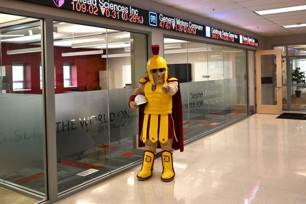 Sparty stands in front of the newly built Entrepreneurship Center, holding a construction helmet to mark the completion of recent campus renovations.