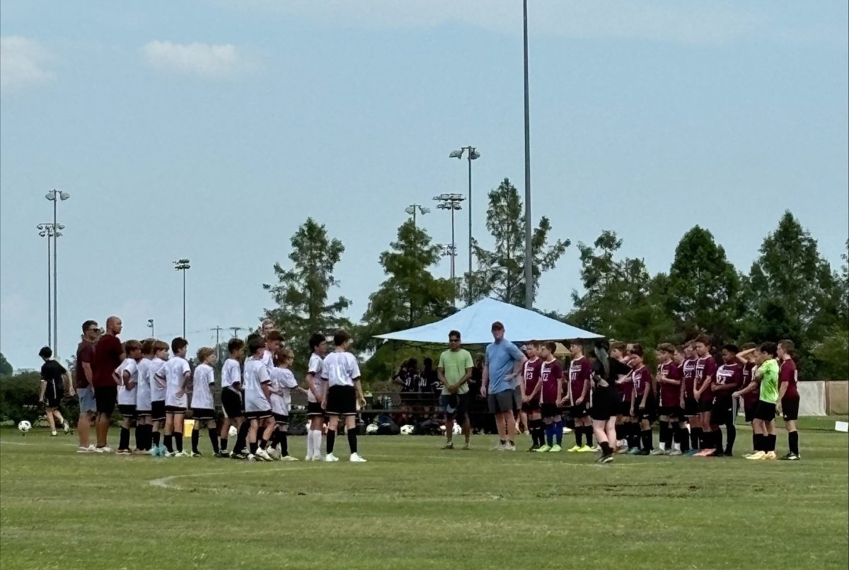 The middle school's CYC team lines up against their opponents in their soccer game. De Smet is in white facing their opponents ready to play.