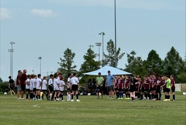 The middle school's CYC team lines up against their opponents in their soccer game. De Smet is in white facing their opponents ready to play.