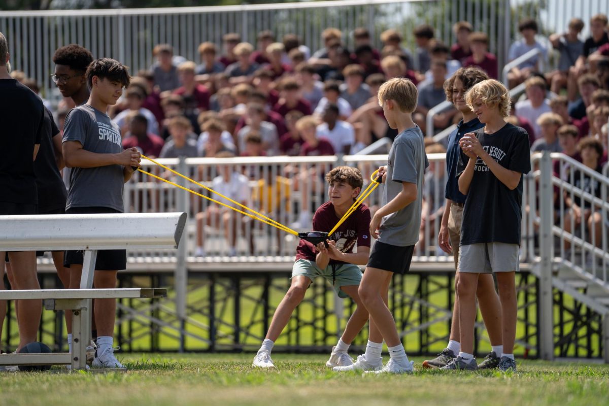 Jack Henry 29' winds up to release a water balloon at a target to secure the win at freshman odyssey for the class of 2029.