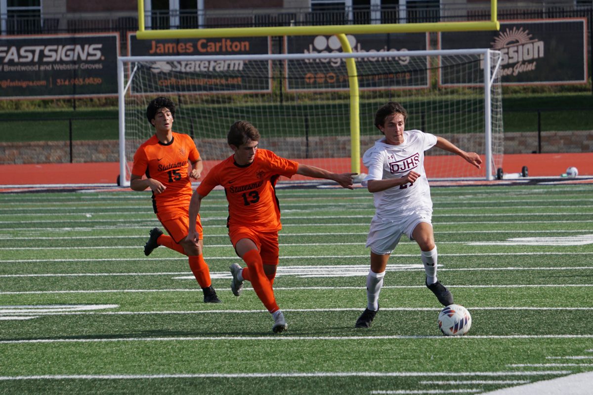A soccer player dribbles past defenders during the Soccer Jamboree on Friday, August 22.