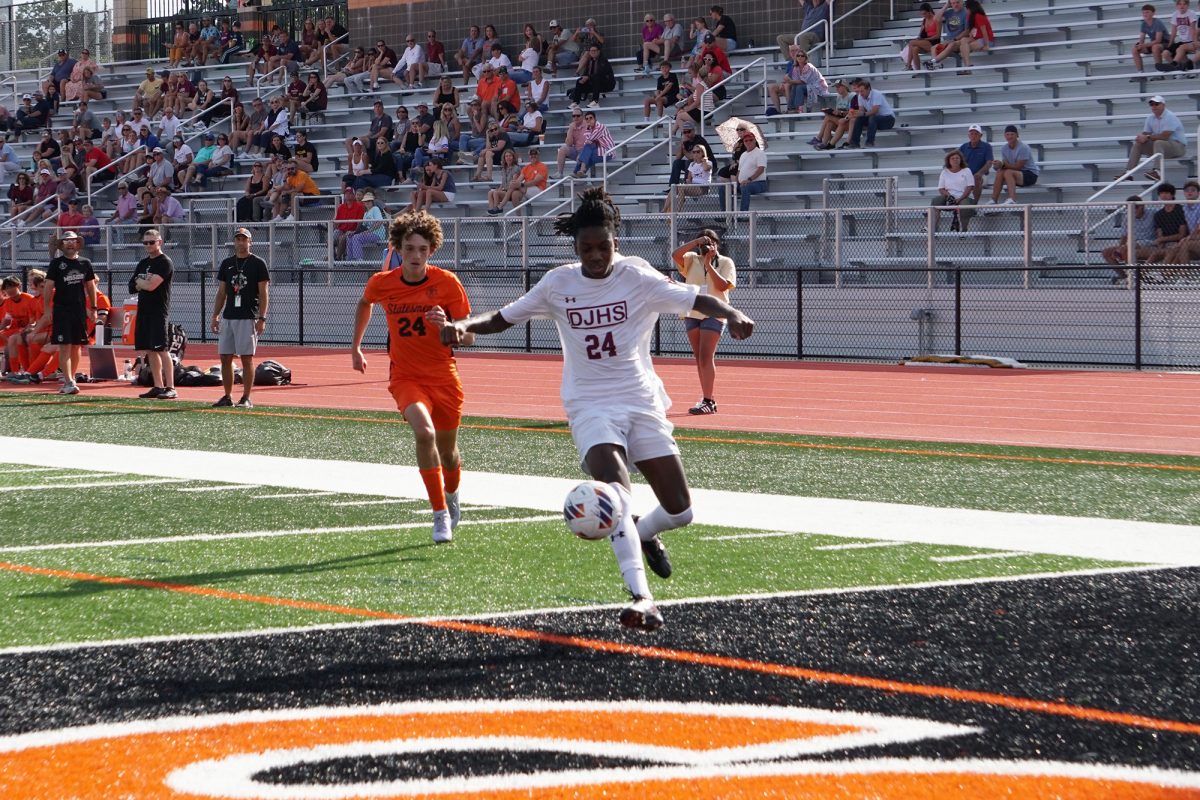 Robert Hammond dribbles past a defender during the Soccer Jamboree on Friday, August 22.