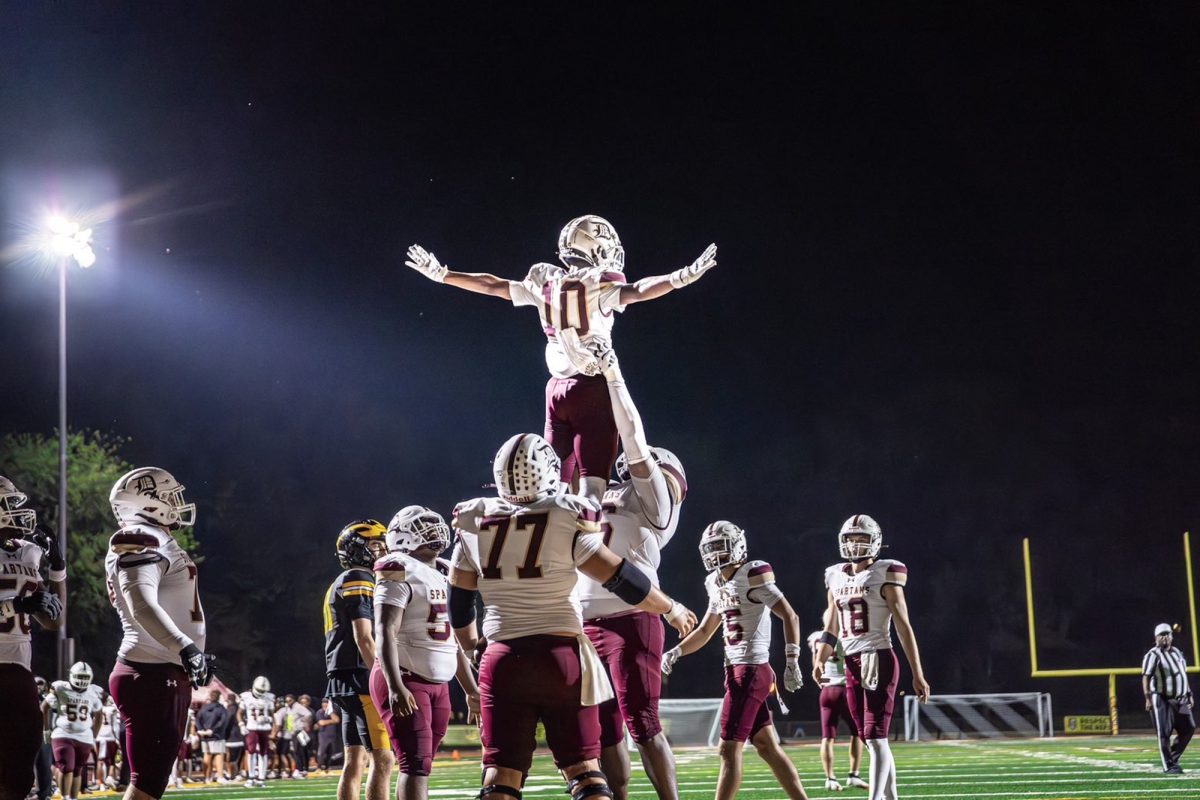 Santiago Castillo lifts Cam Sharp '28 in the air after a touchdown on the game against Vianney. 