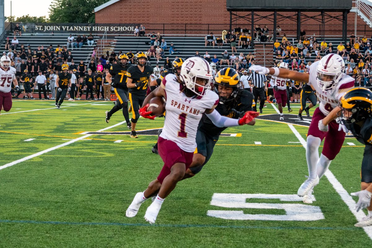Royce Searcy '27 sprints down the sideline for a big gain against Vianney.
