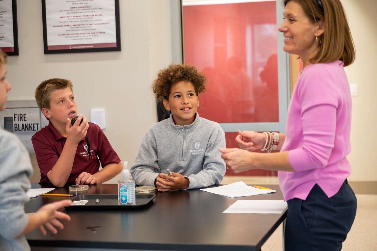 Middle schoolers in a science class doing a lab. 