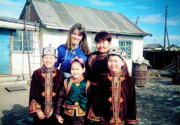 Math Teacher Mrs. Kesner standing with Mongolian children. Photo courtesy of Tawny Kesner. 
