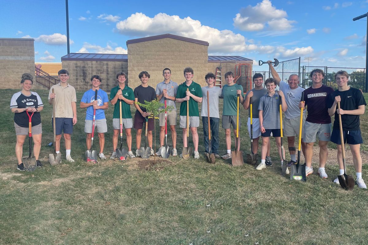 Members of the Green De Smet club admire one of the 20 trees they planted around campus Oct. 6. They plan to plant 300 trees over the next five years.