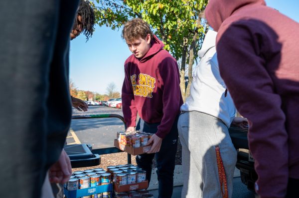 Gus Bilger '27 stacks cans during the GIC collection day on Nov. 6th