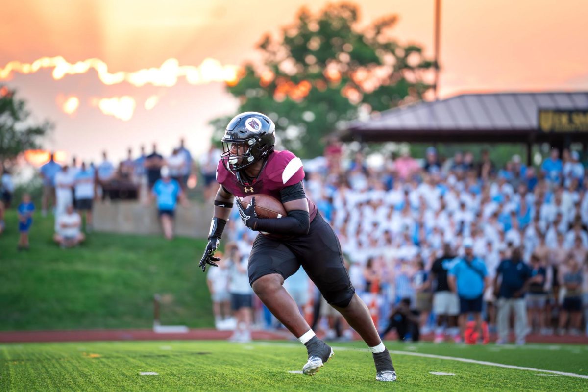 Emmanuel Scott 26' attempts to get the first down against SLUH on Sept. 12.