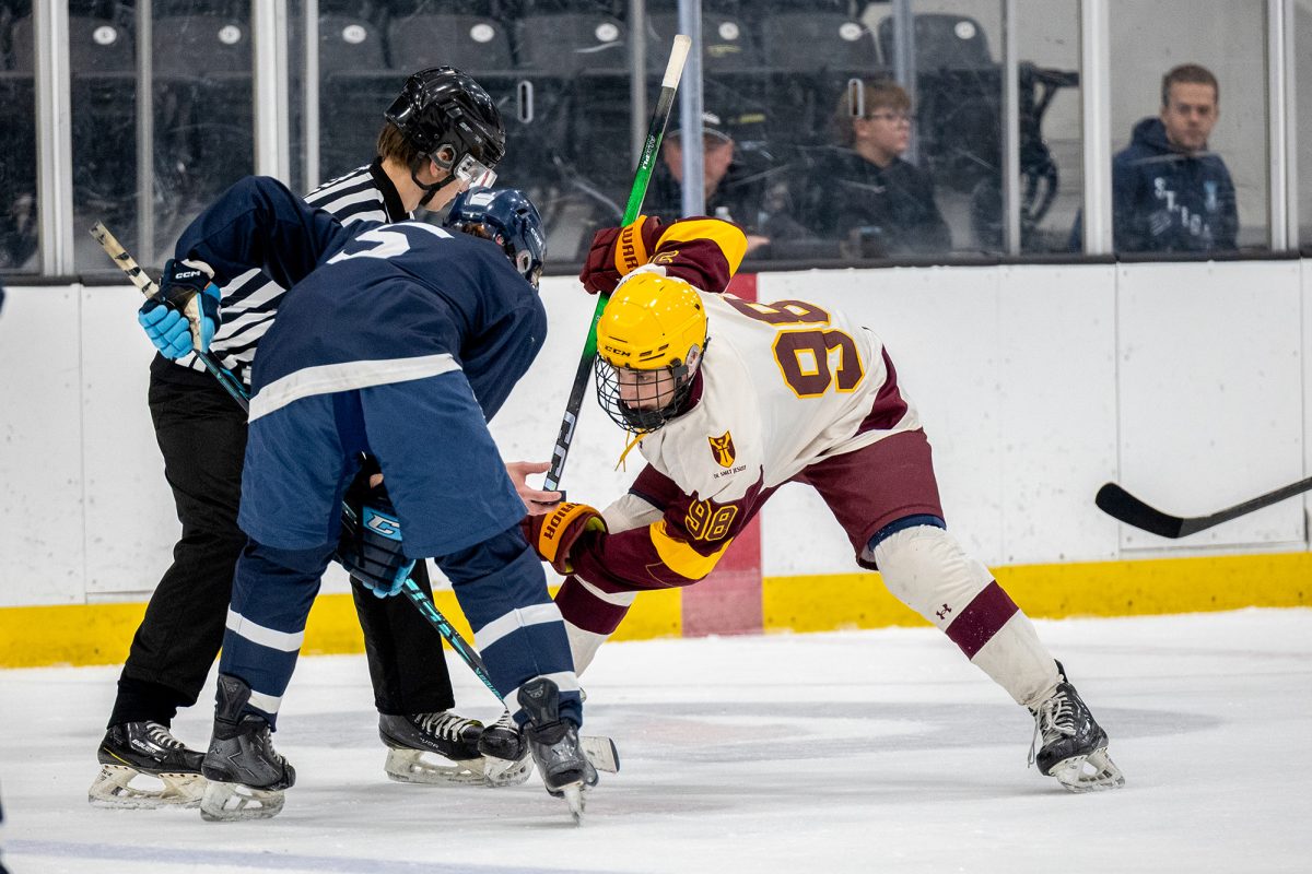 Center Luke Grupe '28 readies to win the face-off during the SLUH game on Jan. 10 2026 